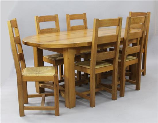 A modern golden oak extending dining table and six chairs, Extends to 7ft 10in. x 3ft 7in. H.2ft 7in.
